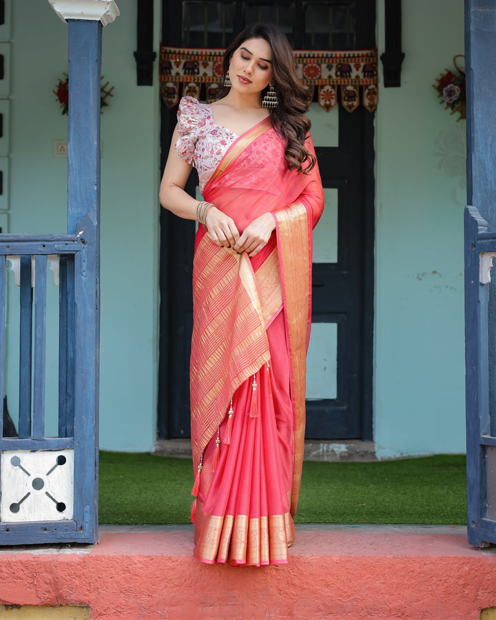 Vibrant Coral Pink Plain Chiffon Saree with Gold Zari Border Floral Ruffled Blouse & Tassel Detailing CHIFFON H 128-132
