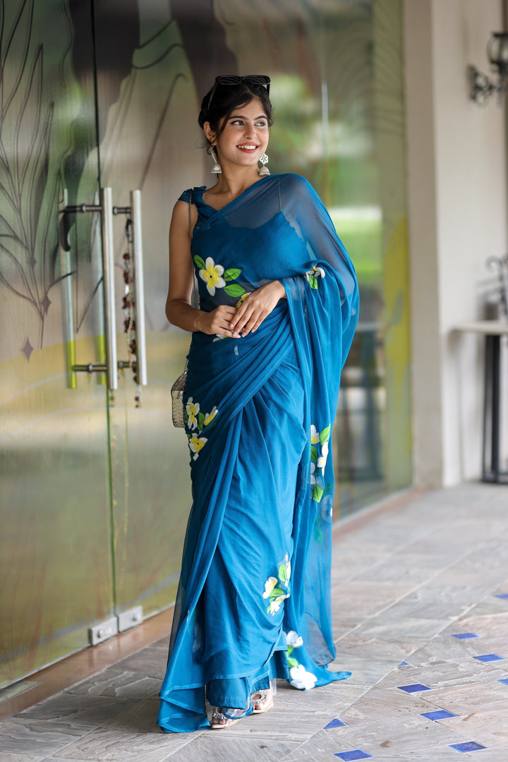 Teal Blue Georgette Saree with Hand-Painted Yellow & White Floral Motifs – Attached Blouse – 5.5 Meters