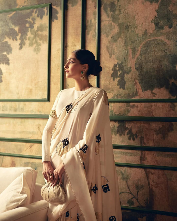 SONAM KAPOOR In Cream Satin Georgette Saree with Golden and Black Calligraphy Print