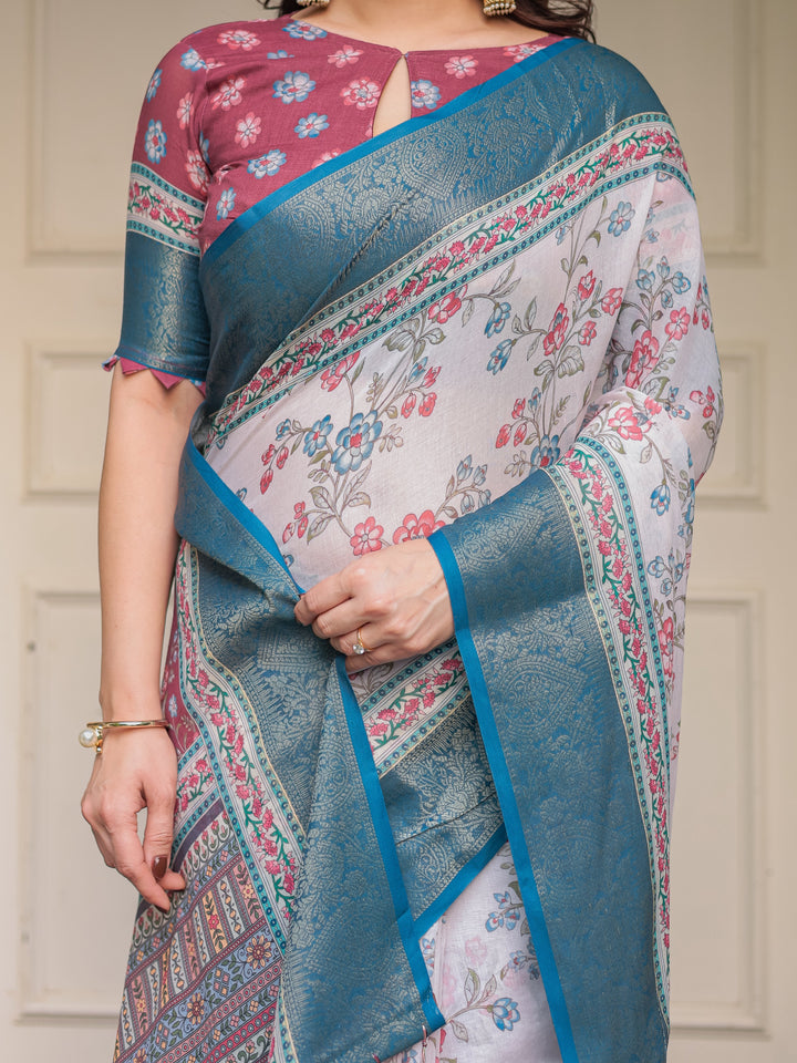 Ivory Floral Printed Saree with Rose Pink & Teal Blue Zari Border & Tassels – Elegant Festive Ethnic Wear