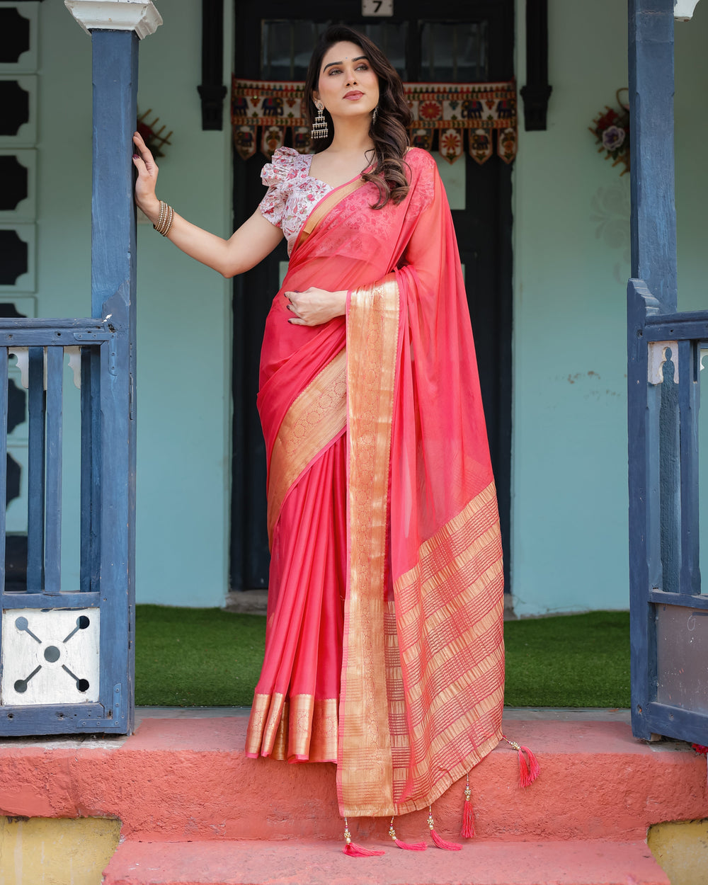 Vibrant Coral Pink Plain Chiffon Saree with Gold Zari Border Floral Ruffled Blouse & Tassel Detailing CHIFFON H 128-132