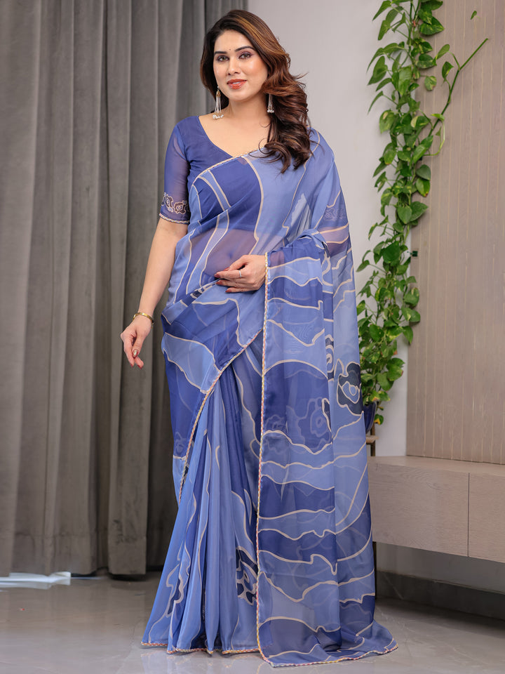 Elegant Steel Blue Printed Organza Saree with Abstract Wave Motifs & Multicolour Lace Border | Designer Lightweight Organza Saree with Attached Blouse Piece | Contemporary Festive Wear Saree